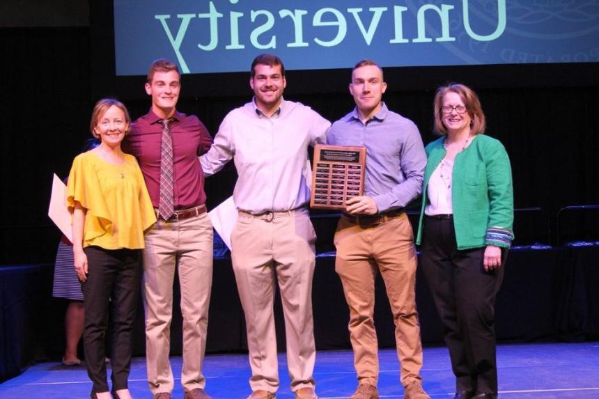 From left: 2018 Henderson Outstanding Tutor Award recipients Noah Pushor in writing, Andrew DelSanto in math, and Ryan Fontaine in science.  They are congratulated by Coordinator of Writing Center Karen Bilotti (far left) and Coordinator of Science Center Tracey McDonnell Wysor (far right).